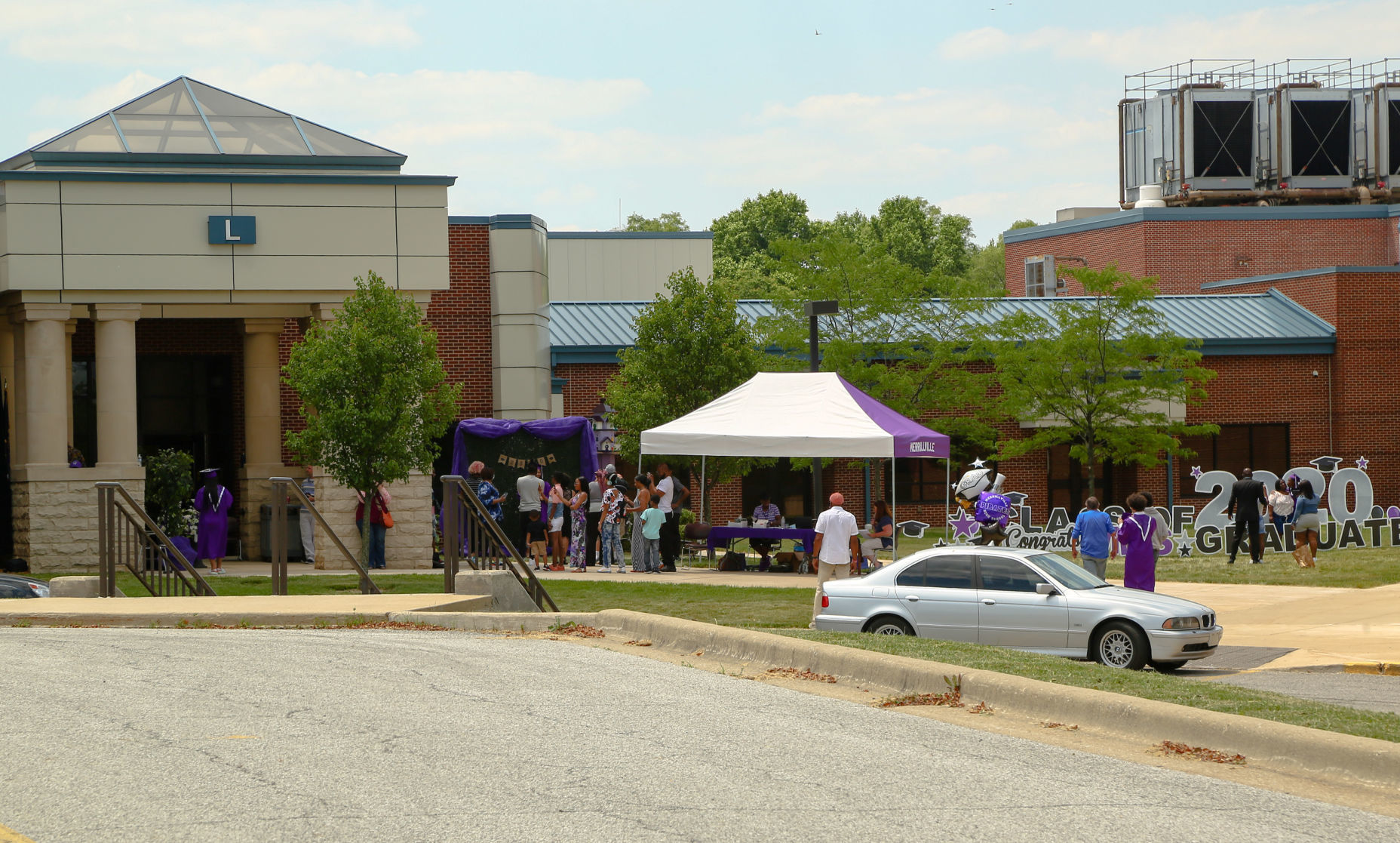Merrillville High School seniors participate in a "drive-up" graduation